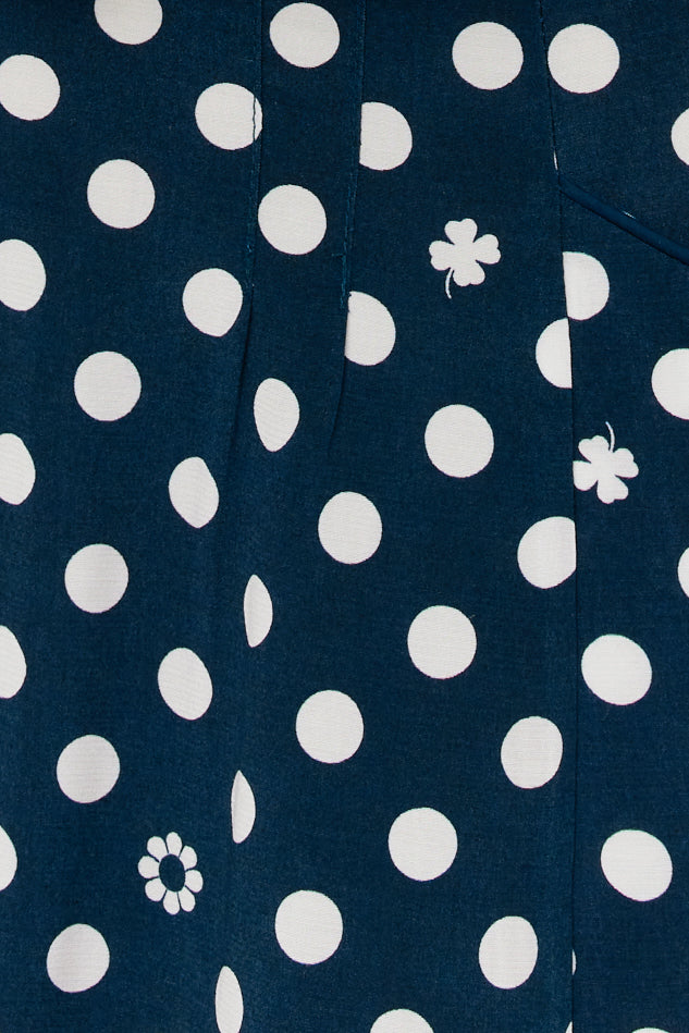 The print is white polkadots on a dark navy base.
