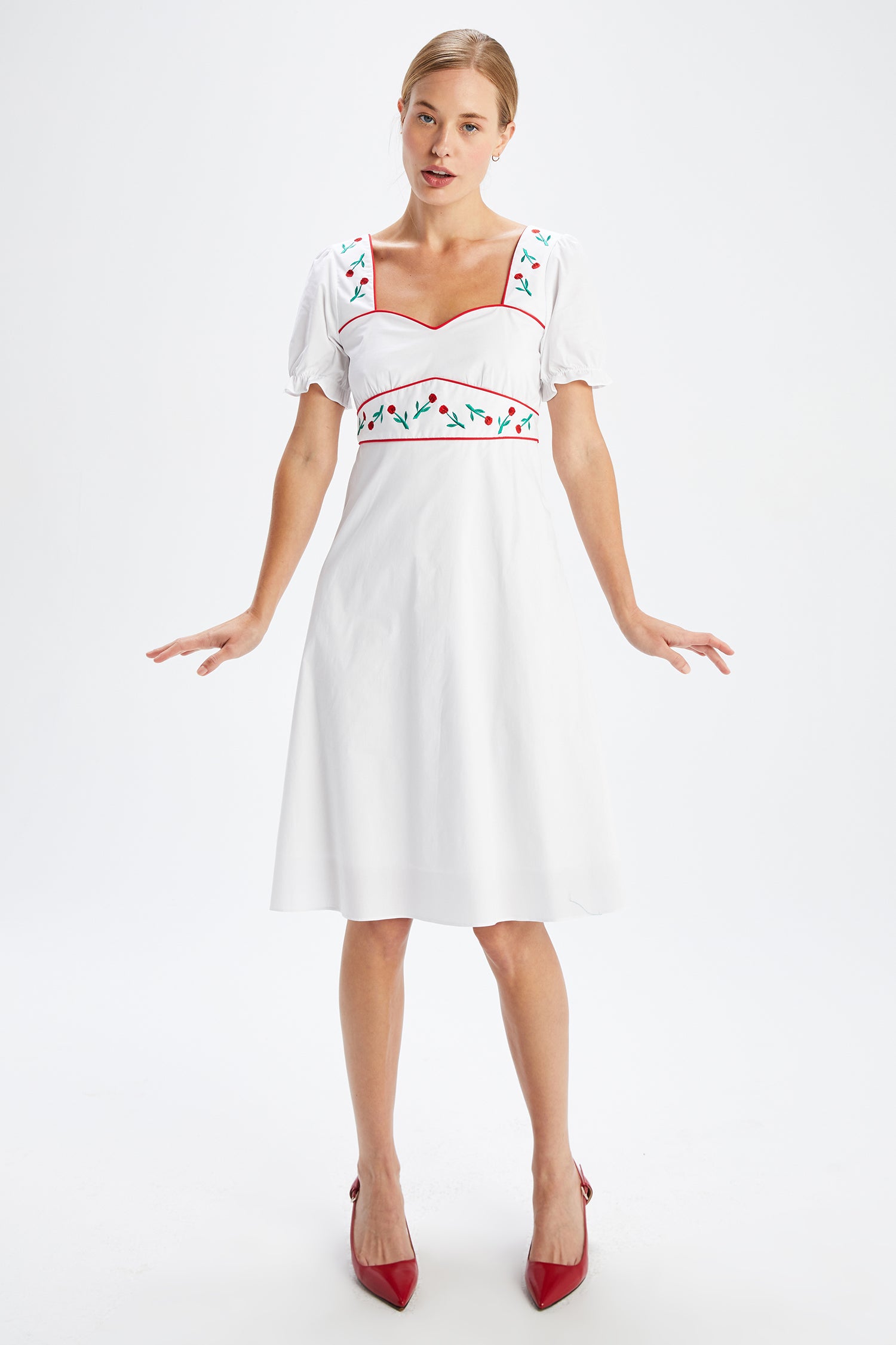 A model wears the Zoey Embroidered Sweetheart Dress