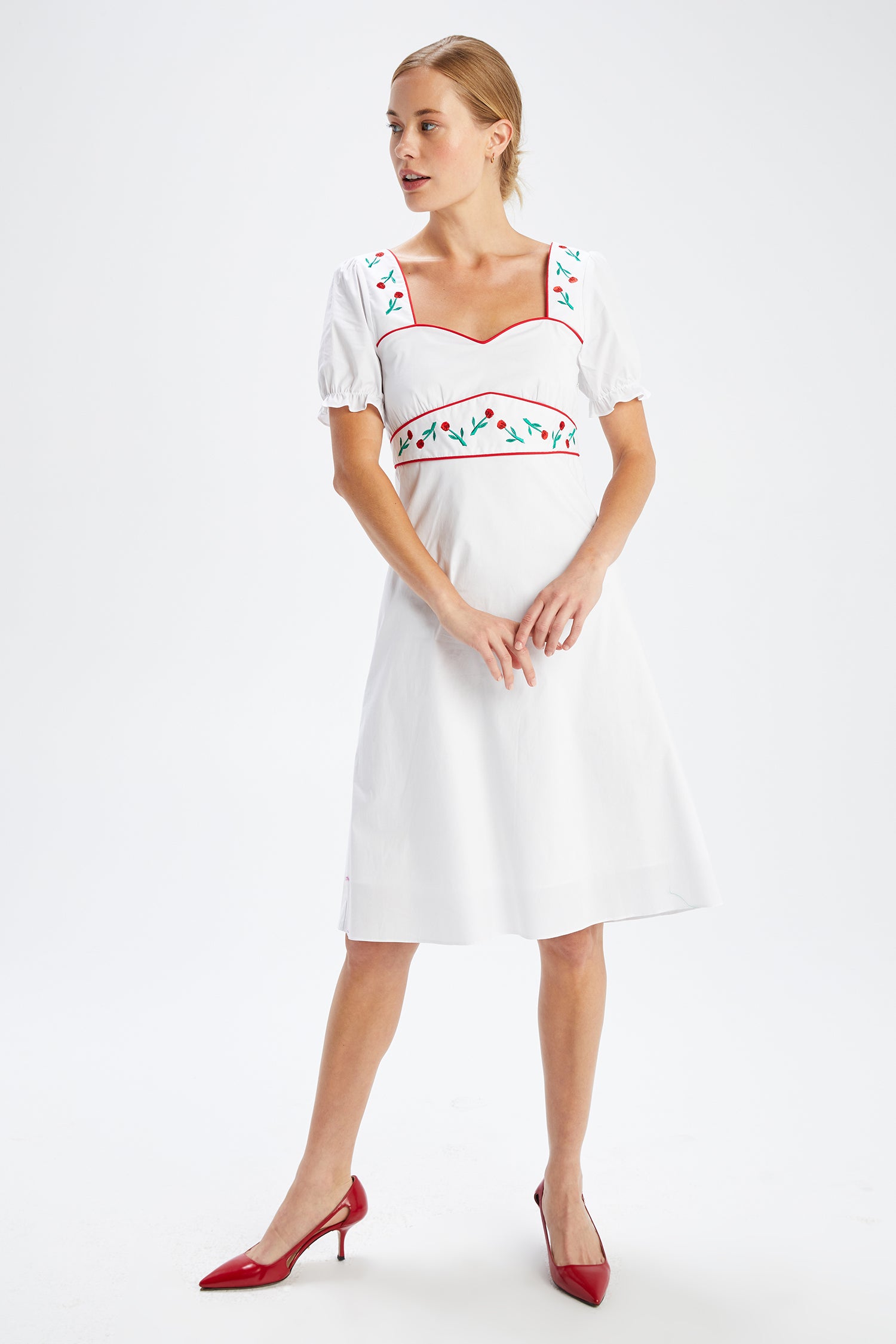 A model wears the Zoey Embroidered Sweetheart Dress
