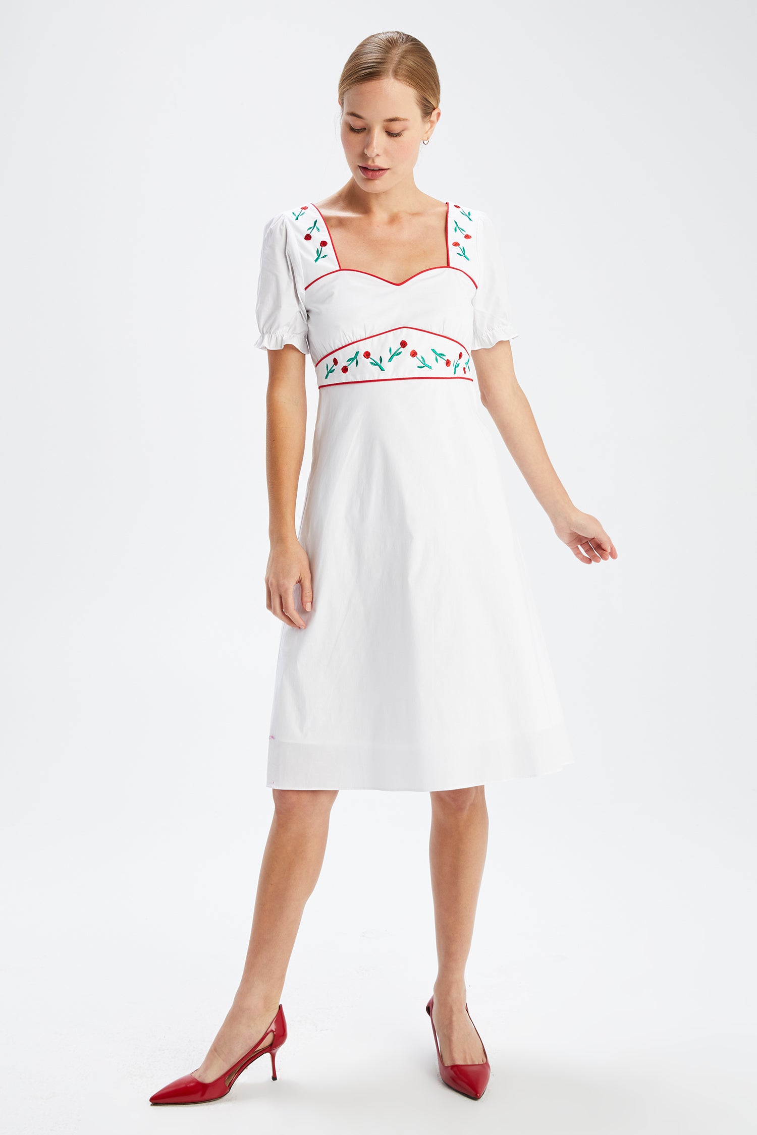 A model wears the Zoey Embroidered Sweetheart Dress