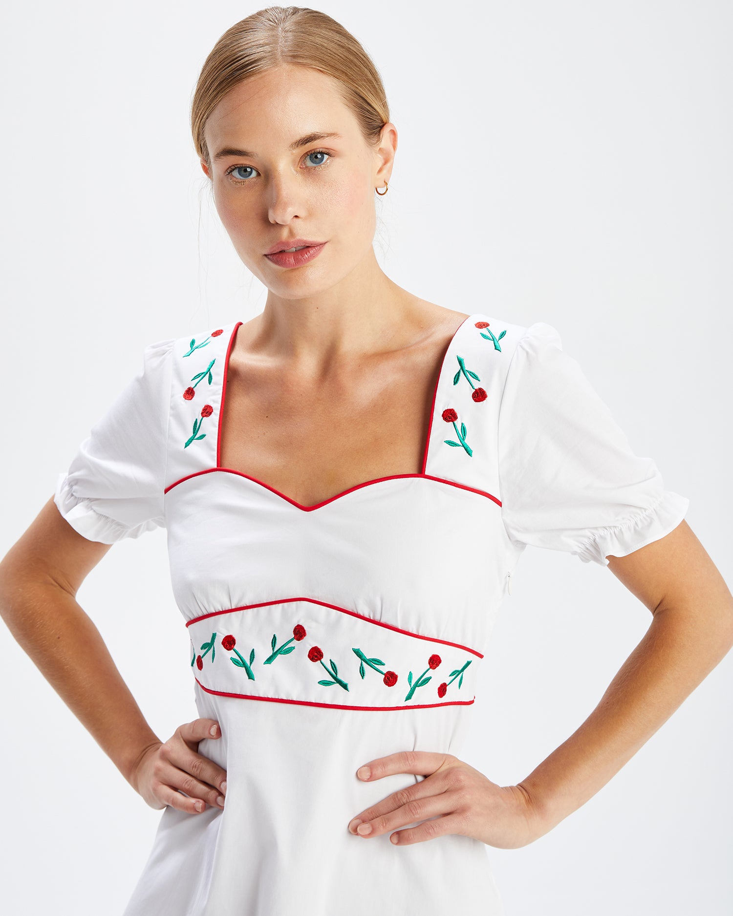 A model wears the Zoey Embroidered Sweetheart Dress