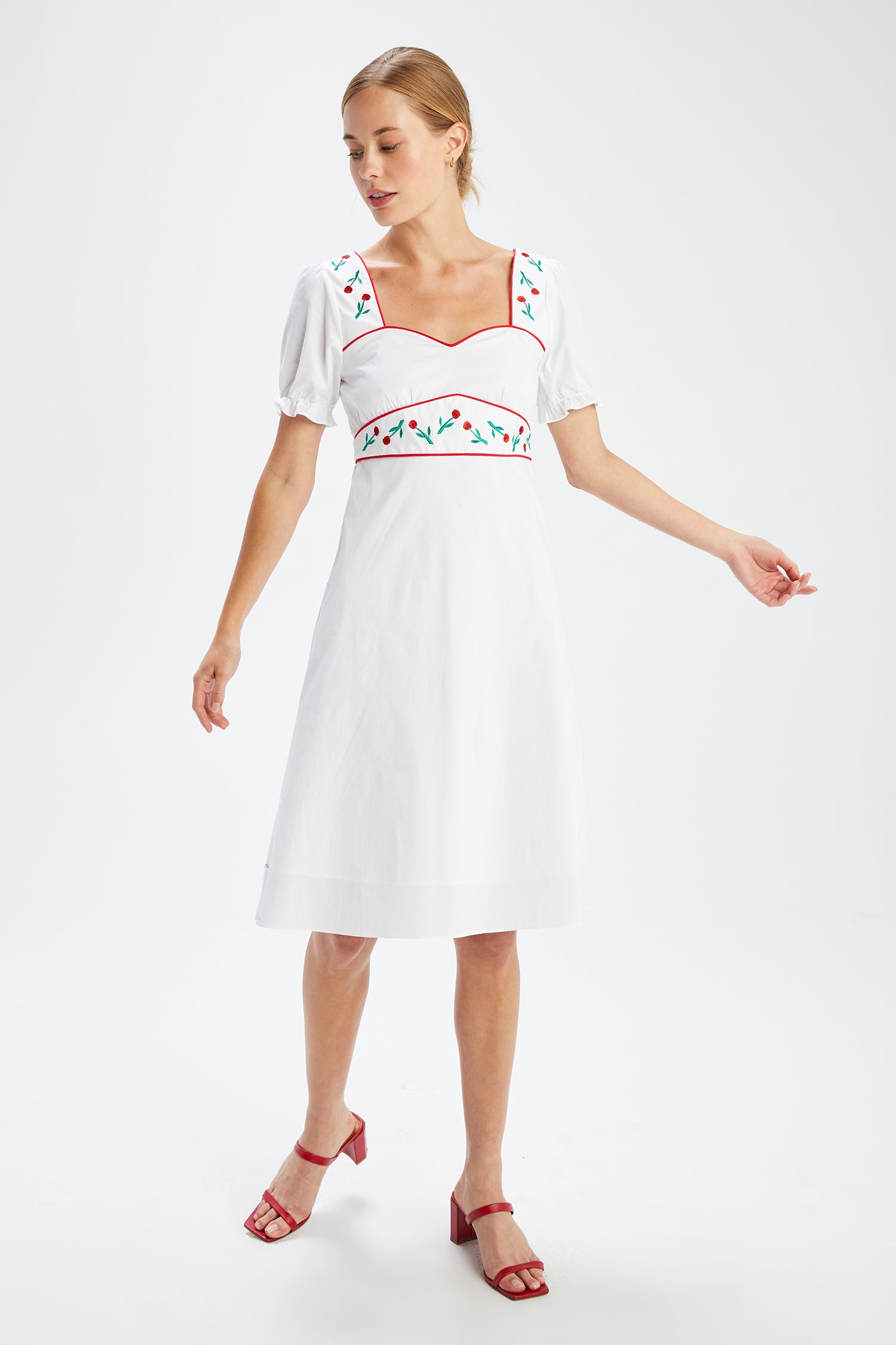 A model wears the Zoey Embroidered Sweetheart Dress