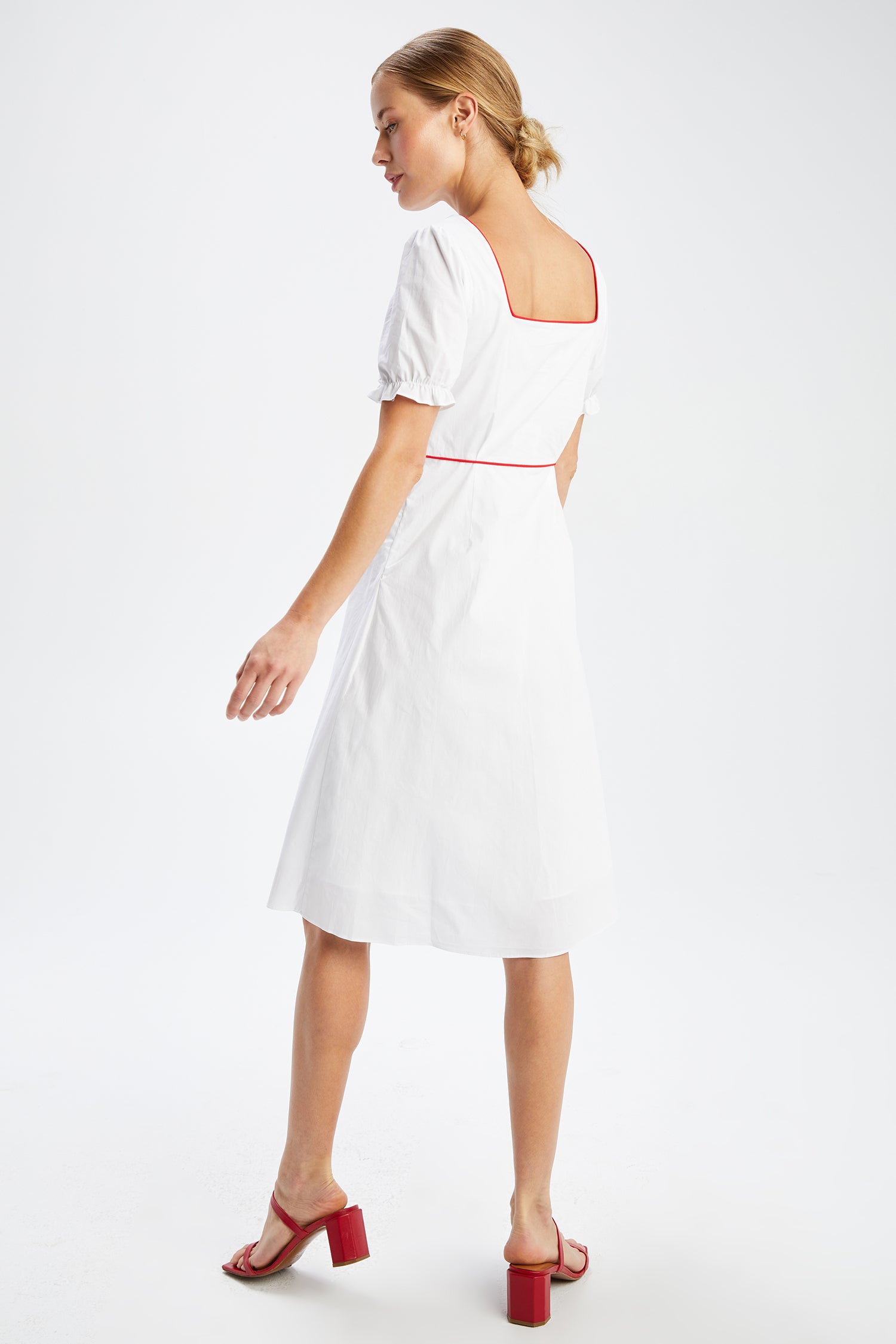A model wears the Zoey Embroidered Sweetheart Dress