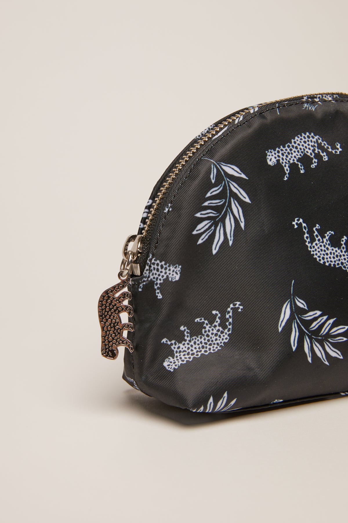 A leopard print cosmetic case with a leopard zip pull.