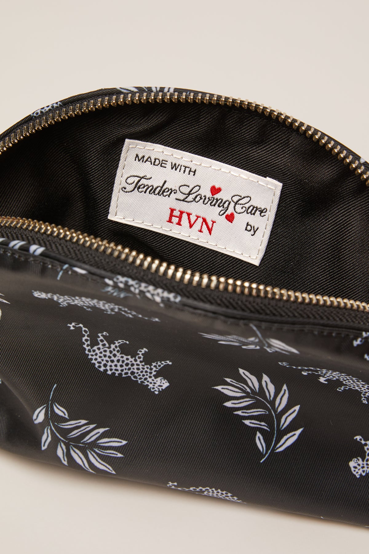 A leopard print cosmetic case with a leopard zip pull.