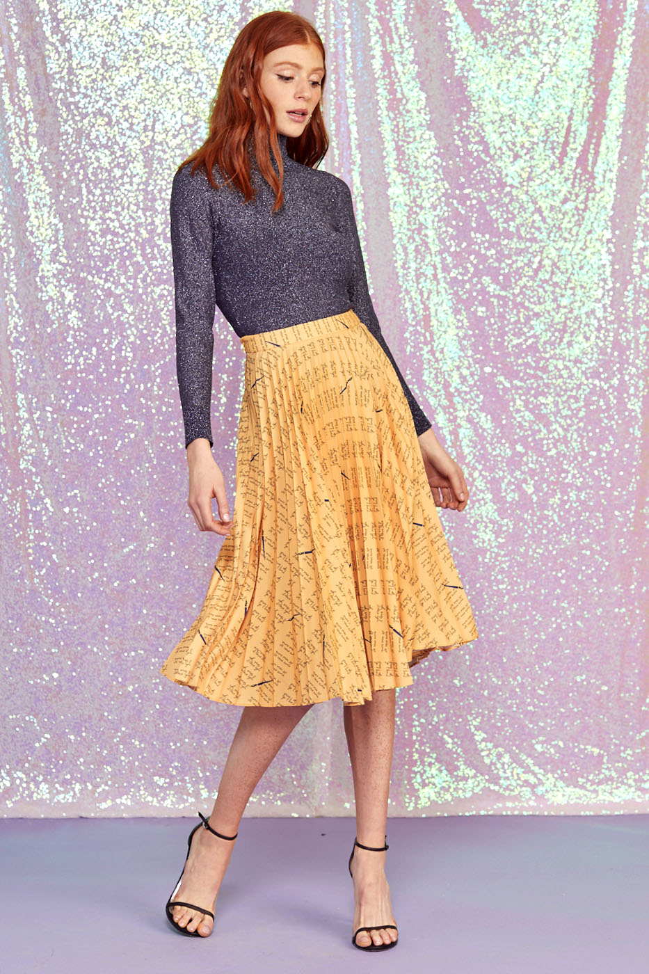 A model wears the Tracy Pleated Skirt