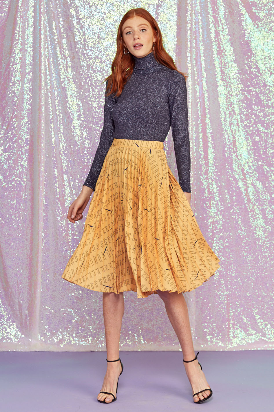 A model wears the Tracy Pleated Skirt