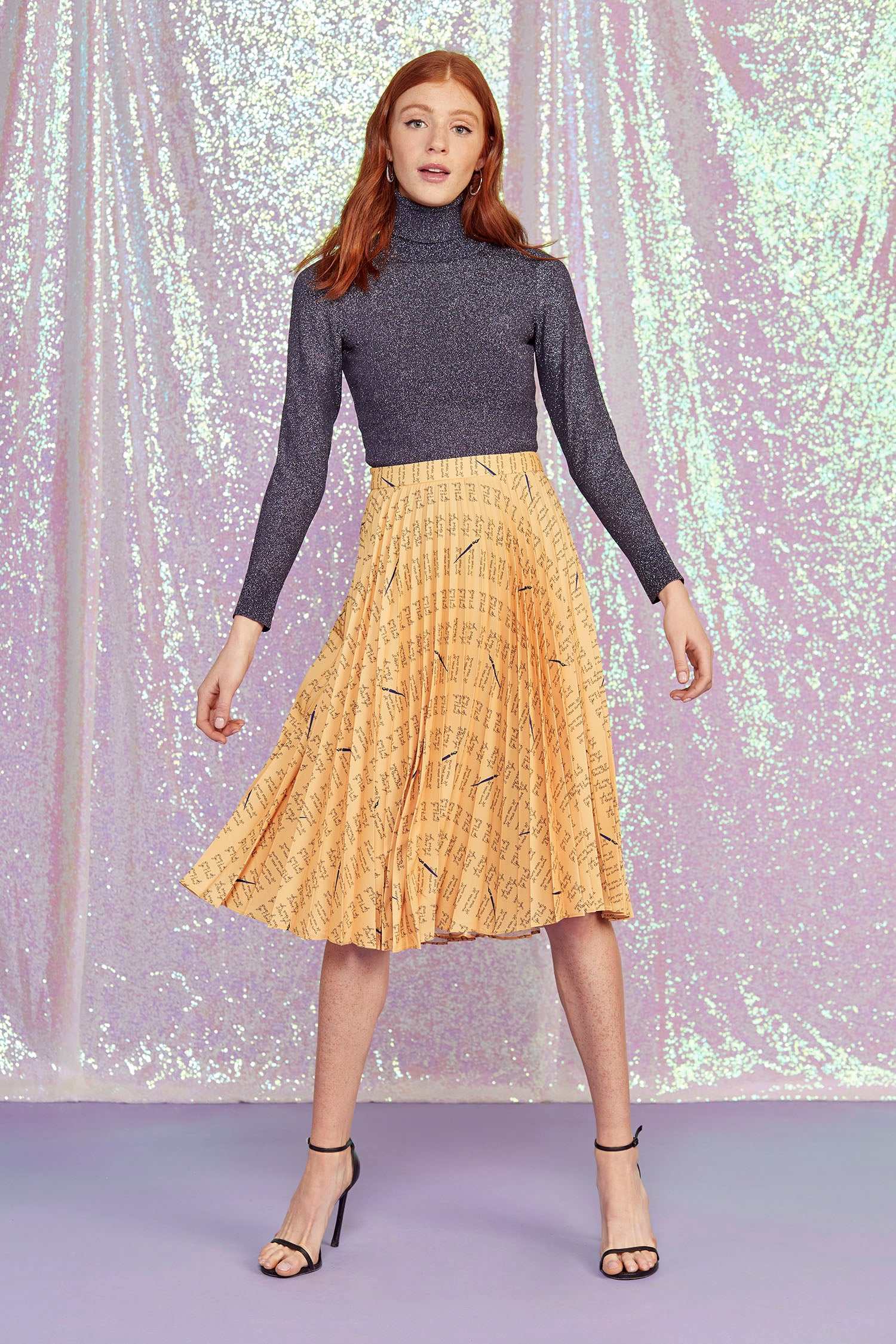 A model wears the Tracy Pleated Skirt
