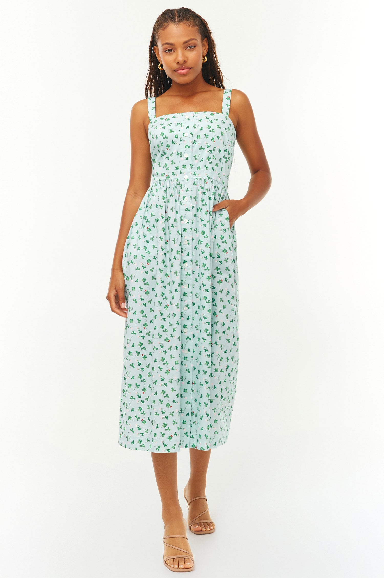 Woman wearing a light blue floral dress on a white background