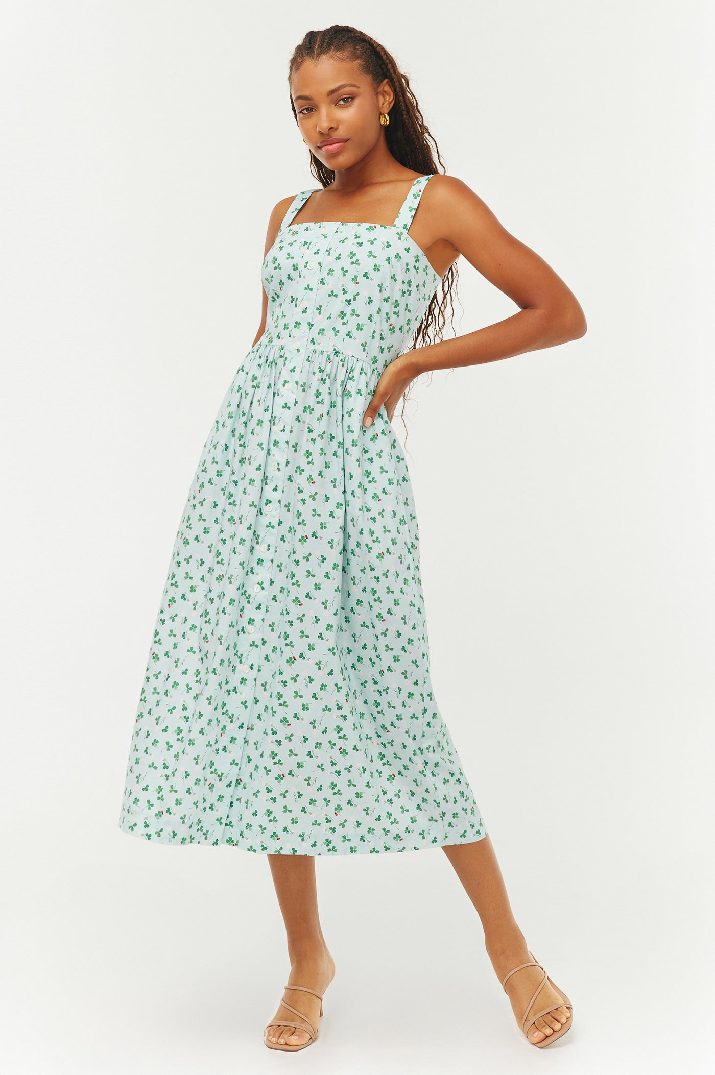 Woman wearing a green floral dress on a white background