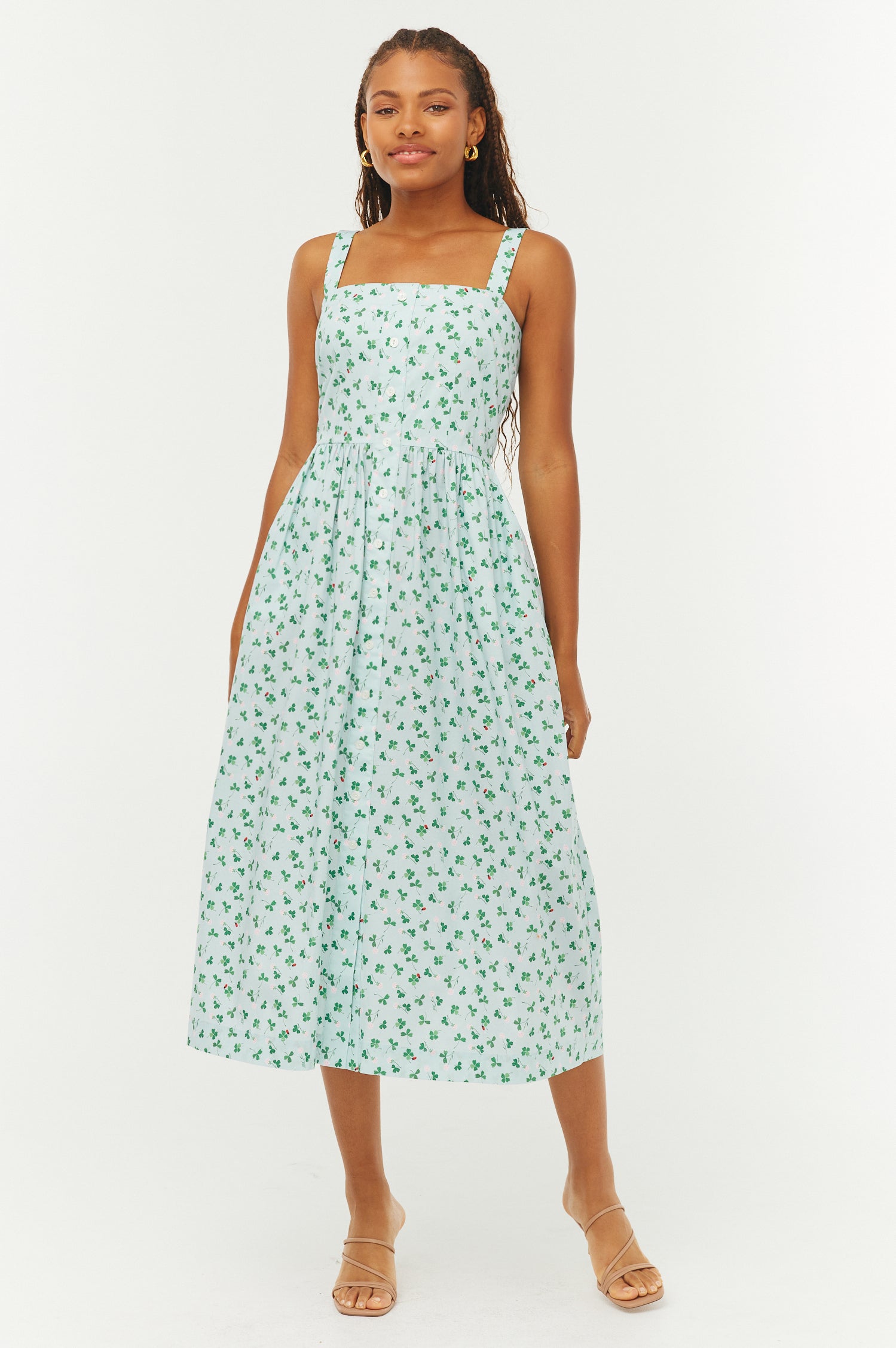 Woman wearing a green floral dress on a white background