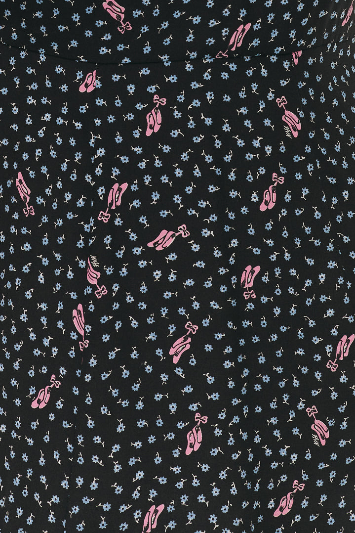 Patterned fabric with small pink ballet slippers and white and blue flower designs on a black background.