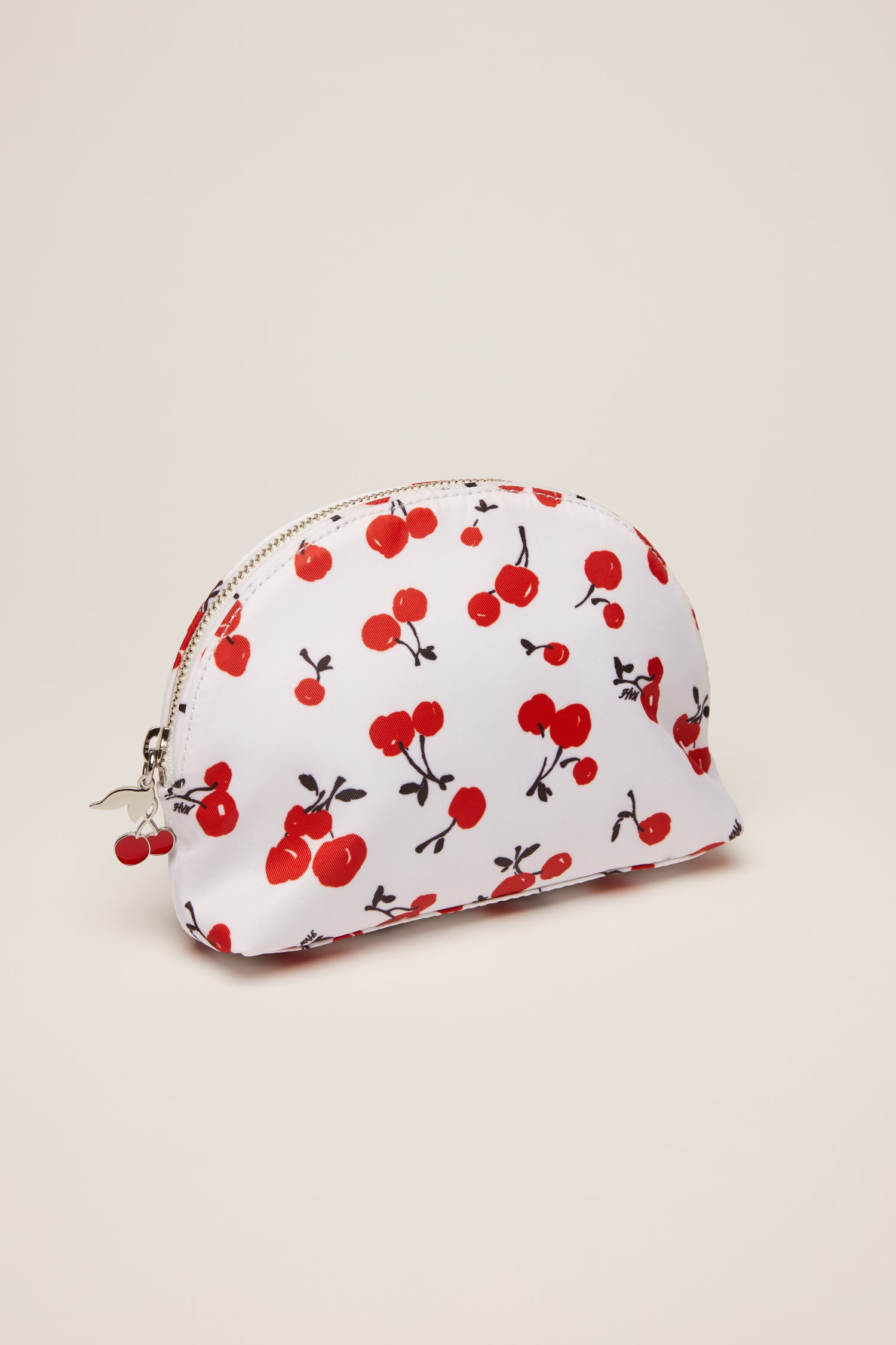 A cherry print cosmetic case with a cherry zip pull. 