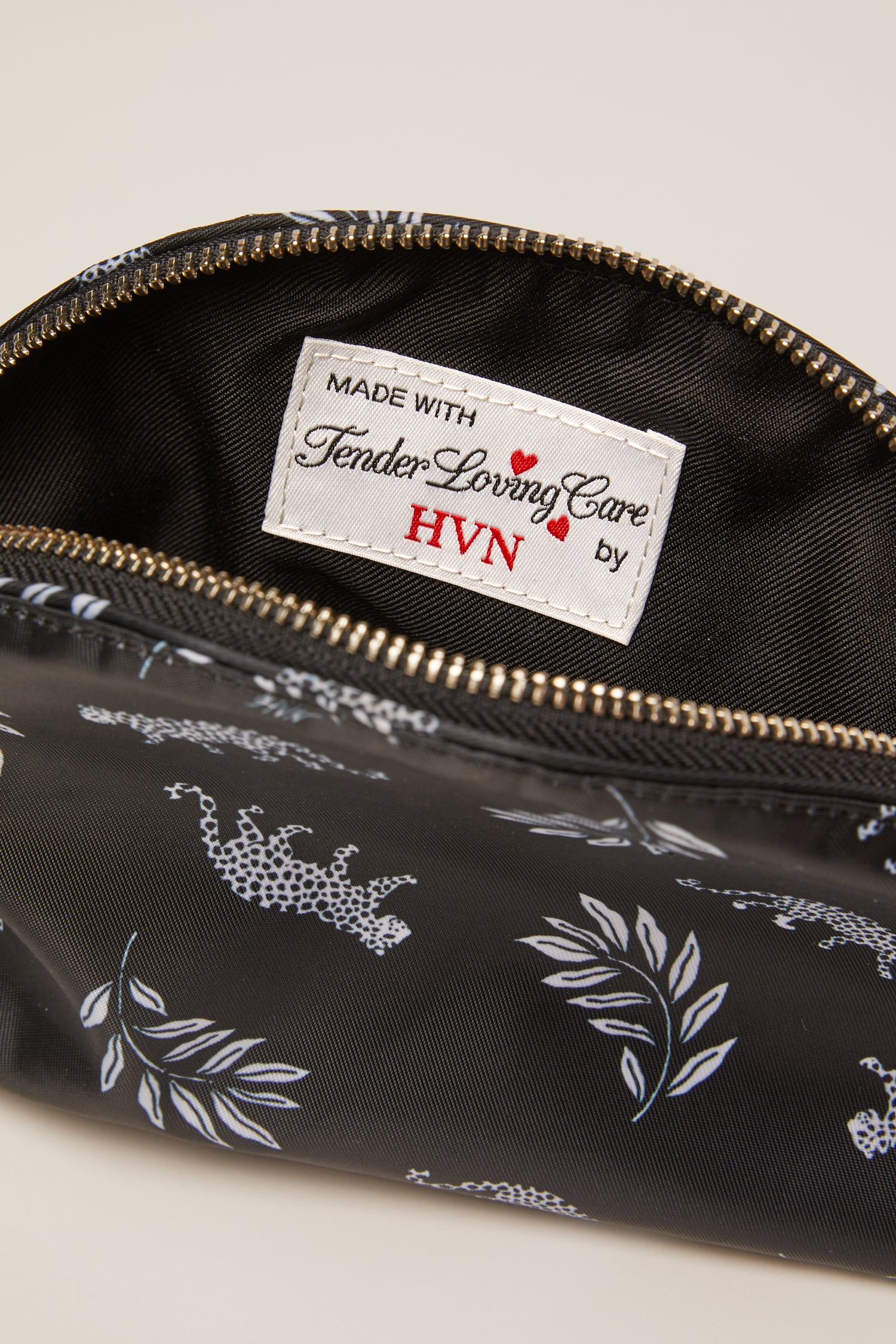 A leopard print cosmetic case with a leopard zip pull.