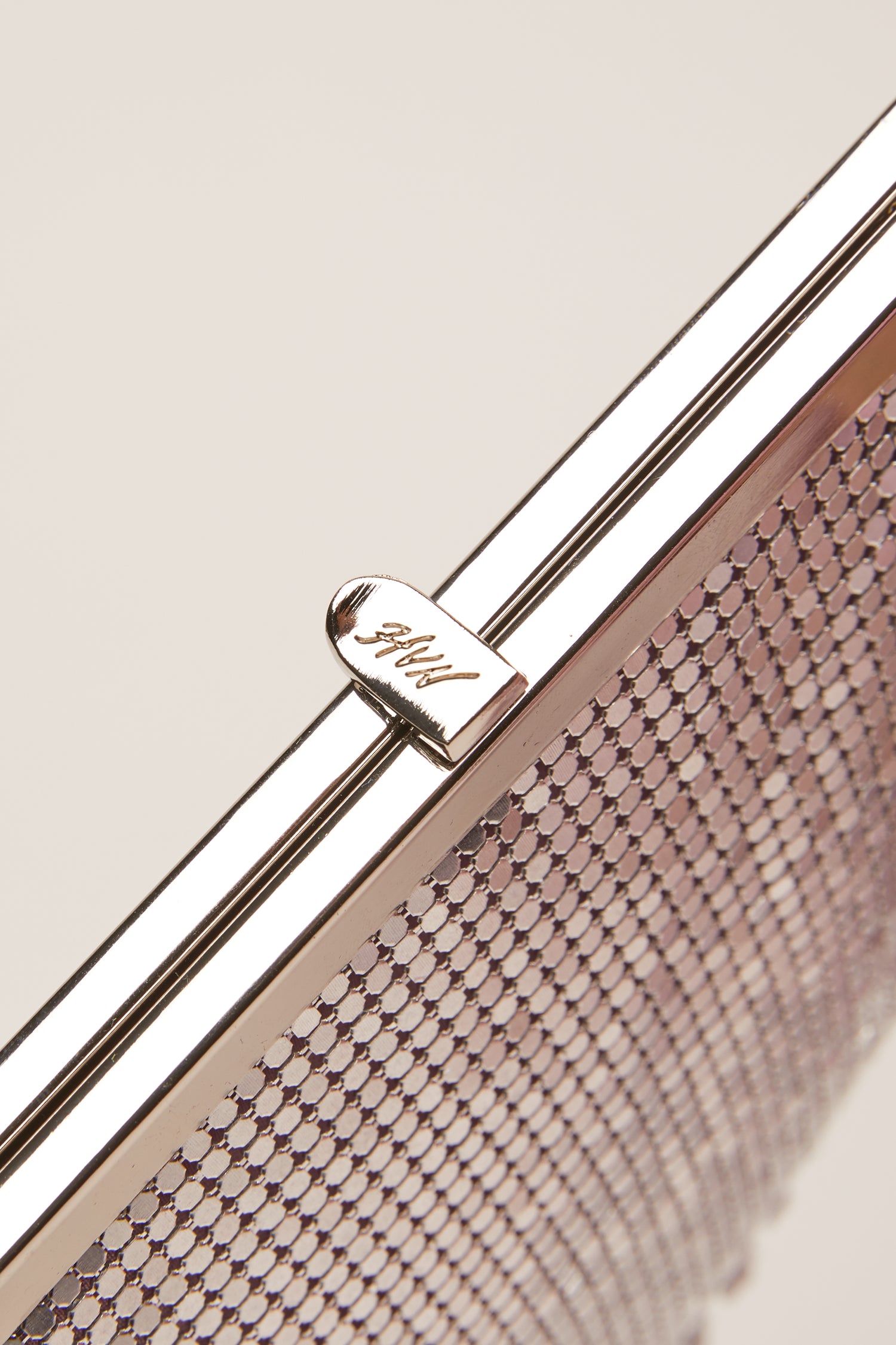 A small silver chainmail bag with the HVN logo on the clasp. 