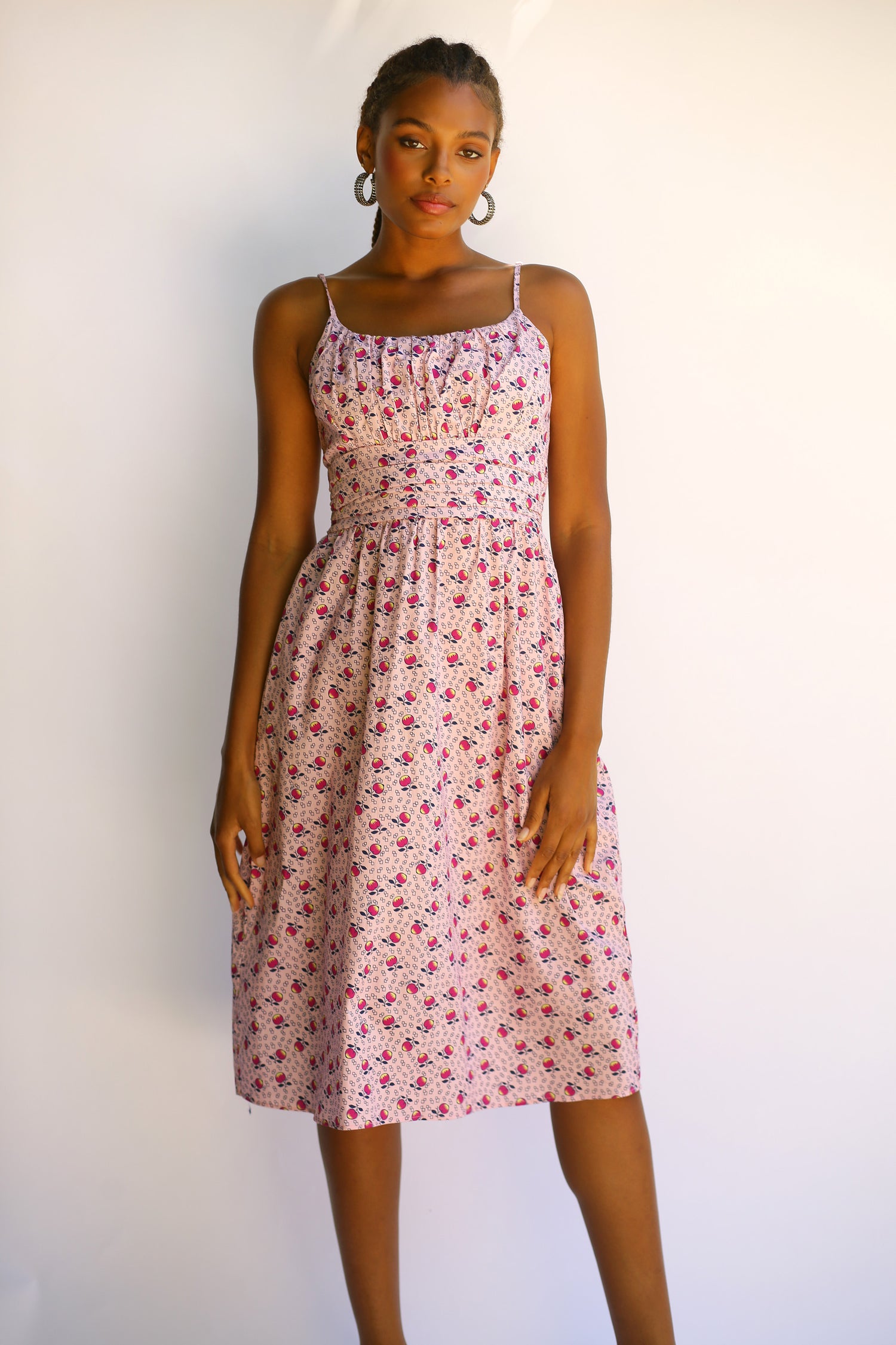 A model wears the Lucy Strappy Cotton Ruched Dress