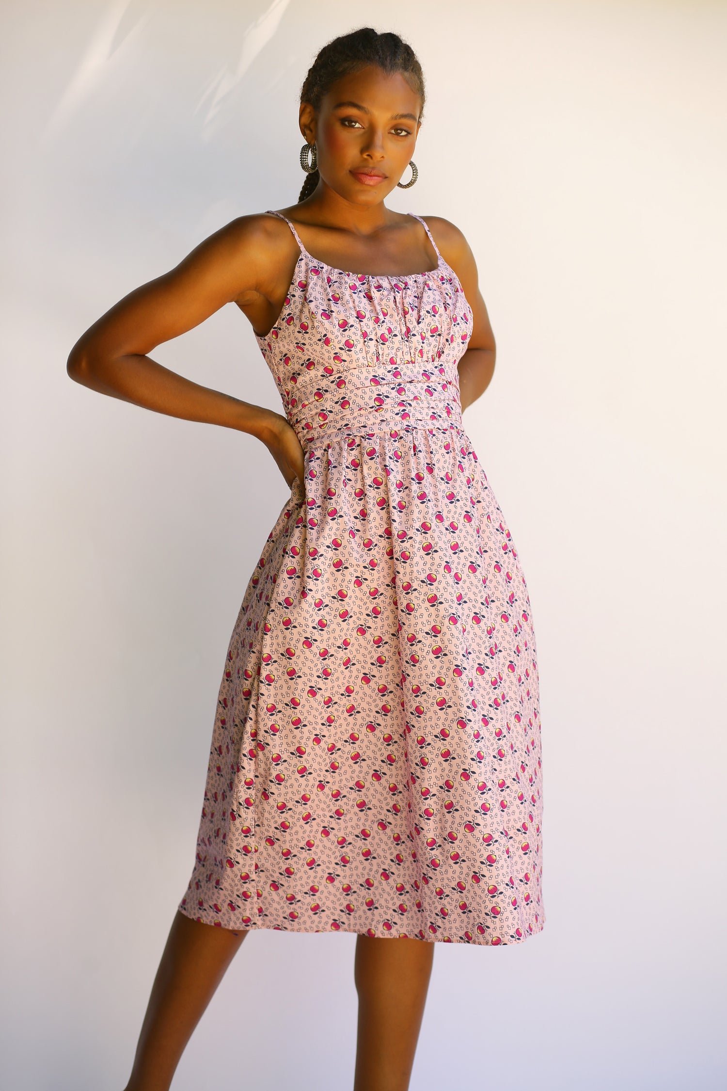 A model wears the Lucy Strappy Cotton Ruched Dress