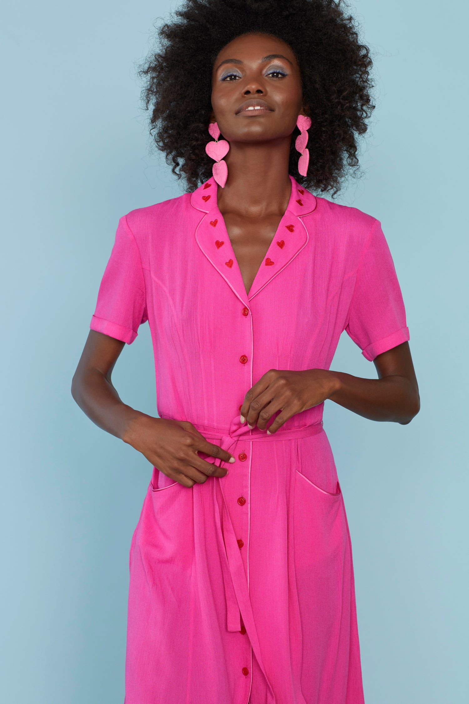 A model wears the Pink Heart Embroidery Maria Dress