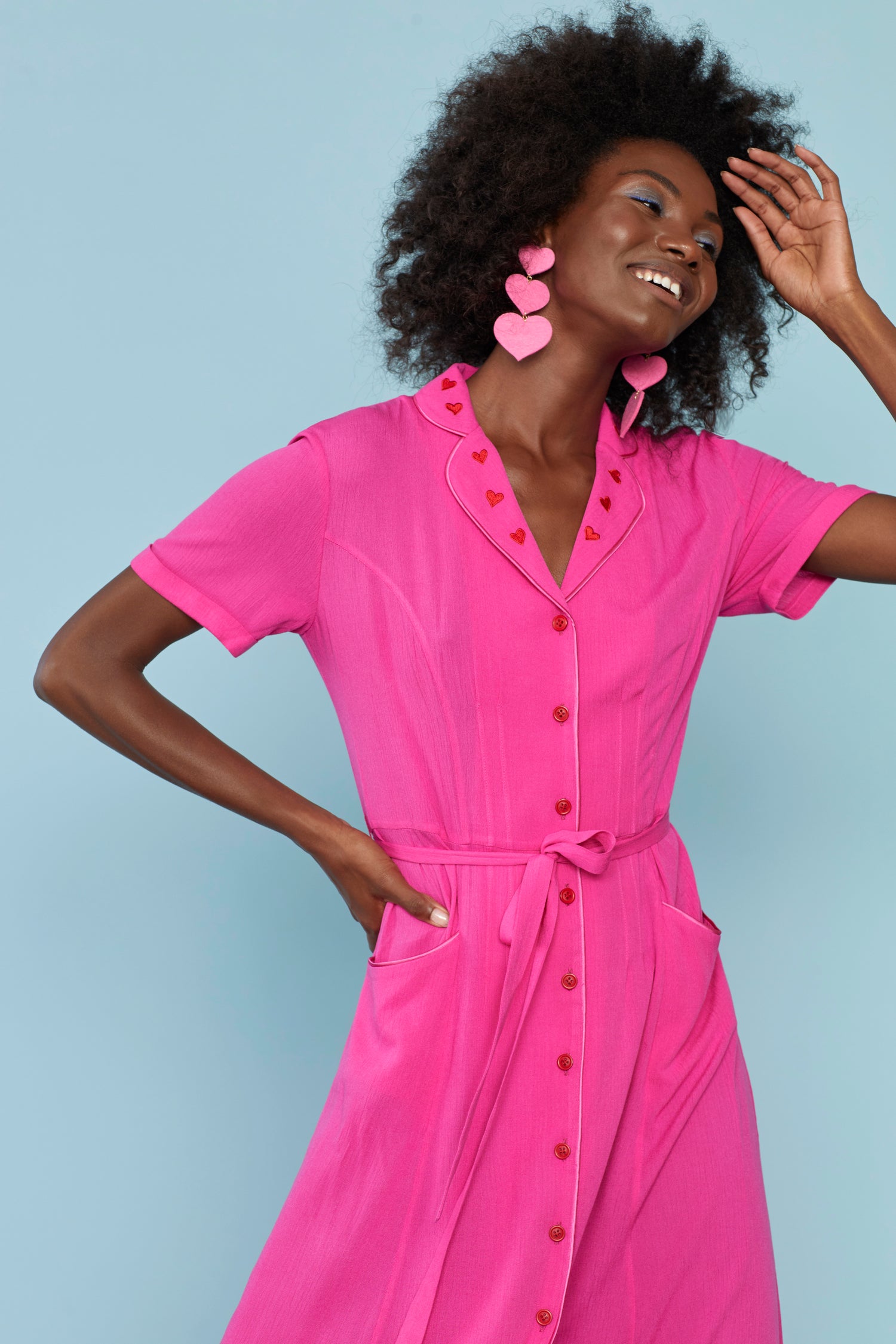 A model wears the Pink Heart Embroidery Maria Dress